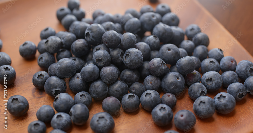 Stack of blueberry on the wooden plate Stack of blueberry on the wooden plate