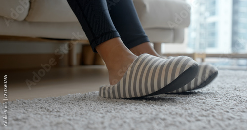 Woman wearing slipper at home photo