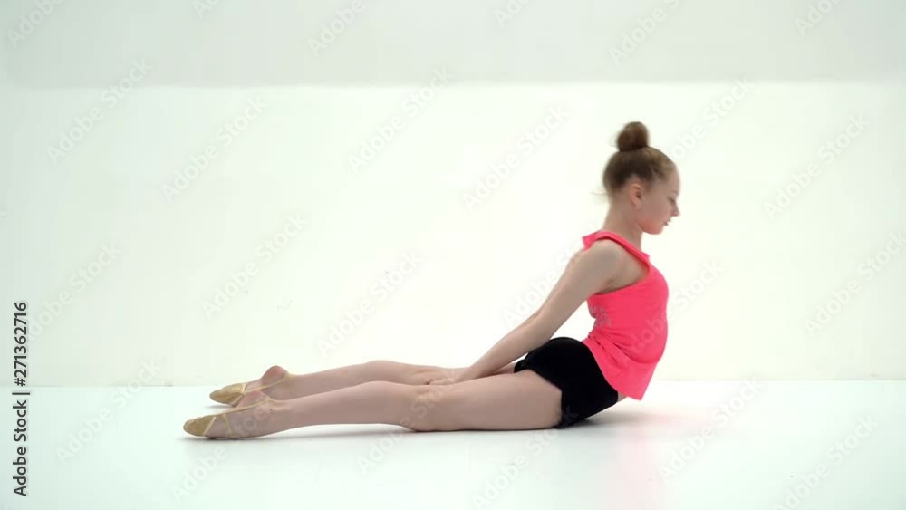 The gymnast perform an acrobatic element on the floor. The gymnast perform an acrobatic element on the floor.