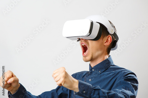 Man with virtual reality headset is playing game.