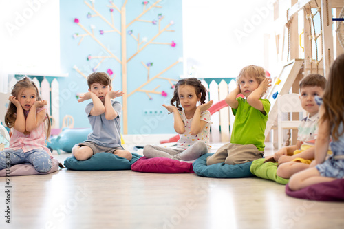 Kids seating on floor and s...