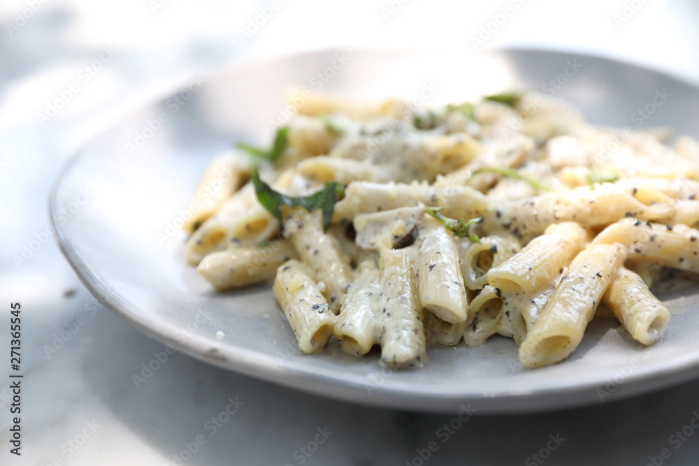 Penne pasta with white sauce and truffle , italian food