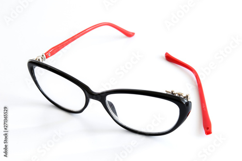 Broken glasses on white background. The concept of optics repair, vision impairment. Vision restoration.