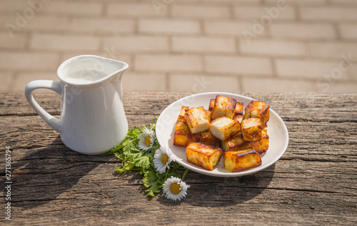 Plate of fried homemade cheese paneer with milk - country meal