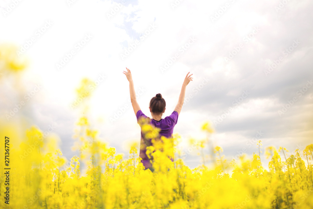 Young happy woman in canola field. Yellow field flowers. Beautiful stylish romantic. Colza, rapeseed. Young happy woman in canola field. Yellow field flowers. Beautiful stylish romantic. Colza, rapeseed.