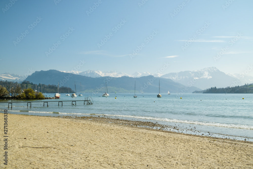 Beautiful view on sandy beach on Lake Lucerne and with Alps in background