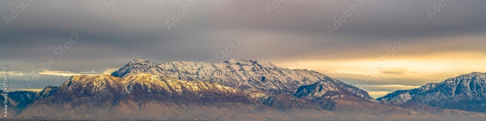 Panorama of a majestic mountain covered with snow and illuminated by sunlight Panorama of a majestic mountain covered with snow and illuminated by sunlight
