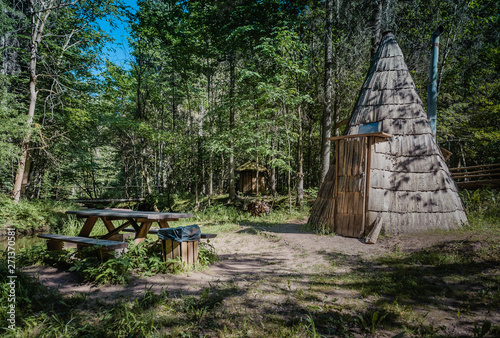 Picnic place next to traditional wooden sauna in forest. Cirulisi nature trails. Latvia. Baltic. photo