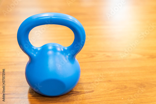 blue kettlebell in a gym.