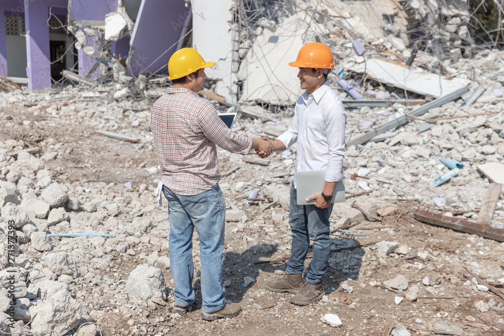 Engineer architect and worker operation control demolish old building.