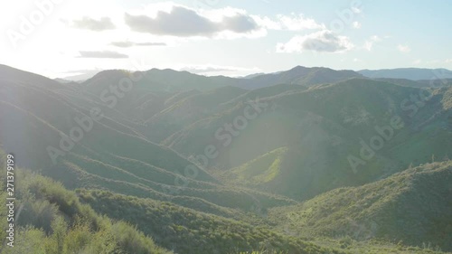 shot of hilly valley in california on sutset covered with grass photo