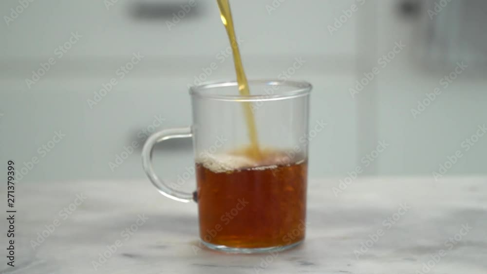 Filling up Turkish tea glass with Turkish tea, ib01 Filling up Turkish tea glass with Turkish tea, ib01