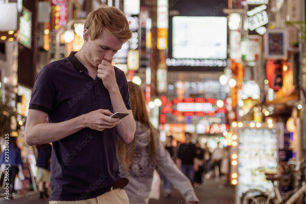 A handsome man looking at his phone