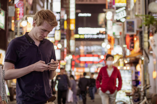 Canvas Print A handsome man looking at his phone