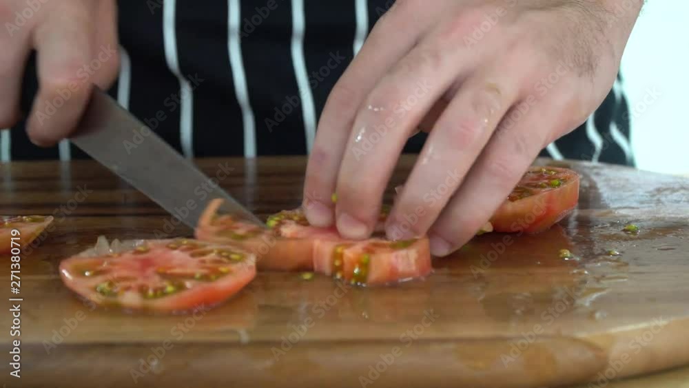 slicing tomato in the kitchen, ib01 slicing tomato in the kitchen, ib01