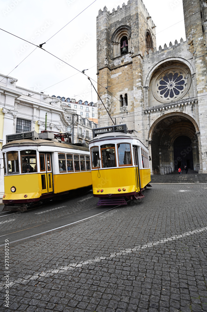 two old trams near Cathedral in Lisbon