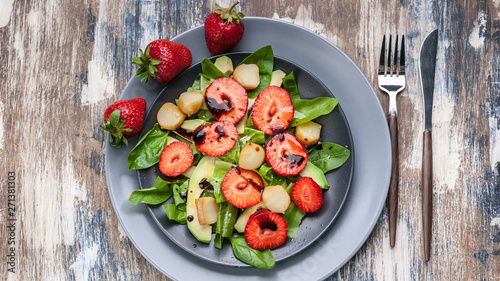 Delicious salad with greens, strawberries and smoked cheese. Tasty and healthy. Top view. Food banner