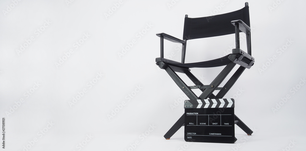 Black Clapper board or movie slate with director chair use in video production or movie and cinema industry. It's put on white background.