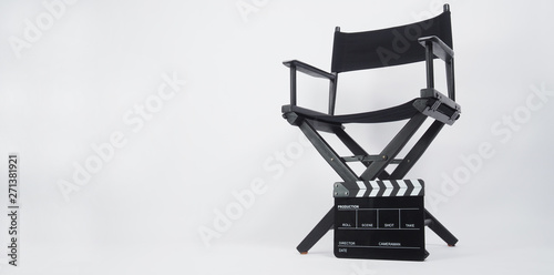 Black Clapper board or movie slate with director chair use in video production or movie and cinema industry. It's put on white background.