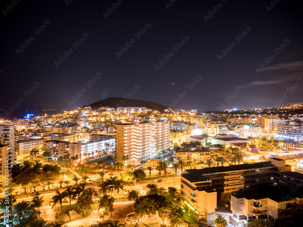 Panoramic view of the Illuminated Las Americas at night with clubs, hotels and bars in Tenerife island, Spain