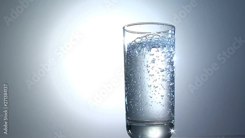 Clean Fresh Water Poured Into Glass, Backlit