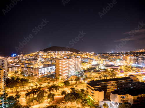 Panoramic view of the Illuminated Las Americas at night with clubs, hotels and bars in Tenerife island, Spain