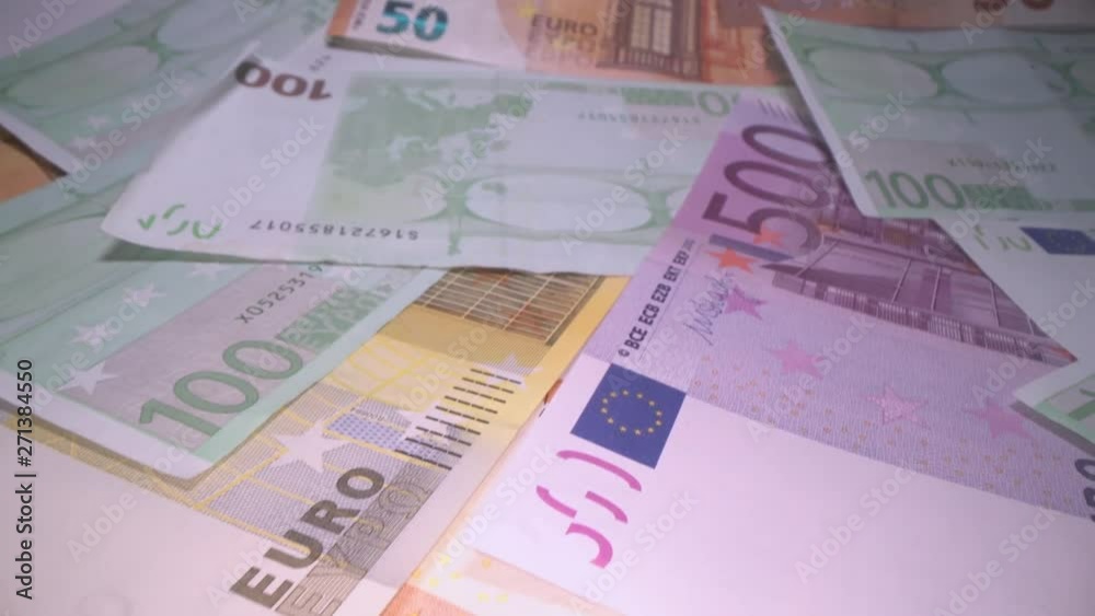 Dolly shot of euro bank notes background stacked on top of each other. Gliding through Euro money banknotes, pile of money, cash, stack of bills. Investing money, savings Dolly shot of euro bank notes background stacked on top of each other. Gliding through Euro money banknotes, pile of money, cash, stack of bills. Investing money, savings