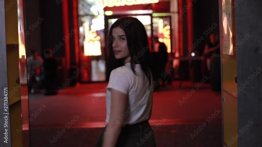 Portrait of beautiful woman at night city in red light