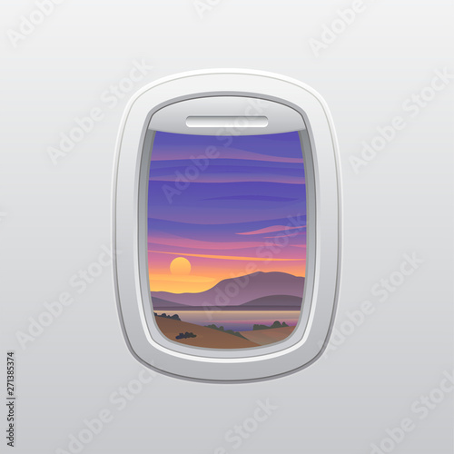 Sunset over the mountains and the sea. View from the window of the plane.