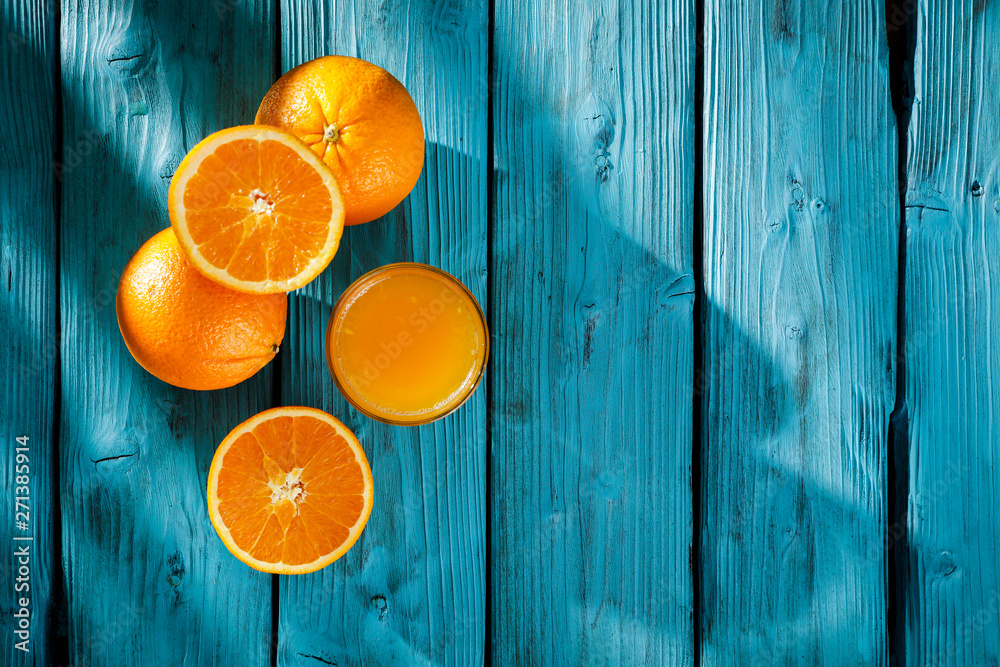 Fresh orange fruits on blue board and summer time. Desk with shadow and free space for your decoration. Healthy nutrition. Fresh orange fruits on blue board and summer time. Desk with shadow and free space for your decoration. Healthy nutrition.