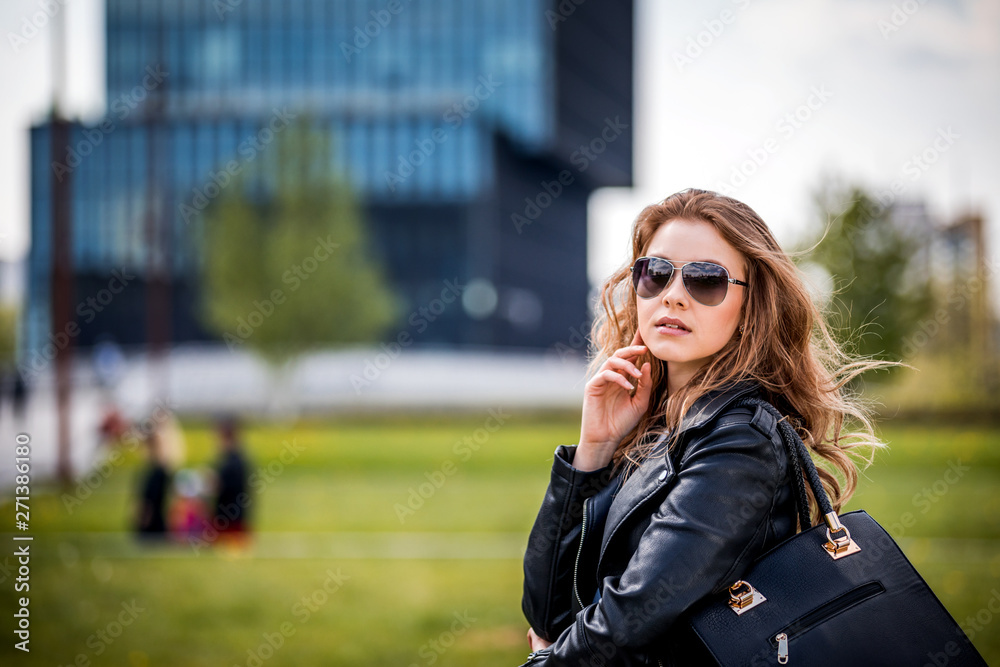 Young woman walking on modern green city area Young woman walking on modern green city area