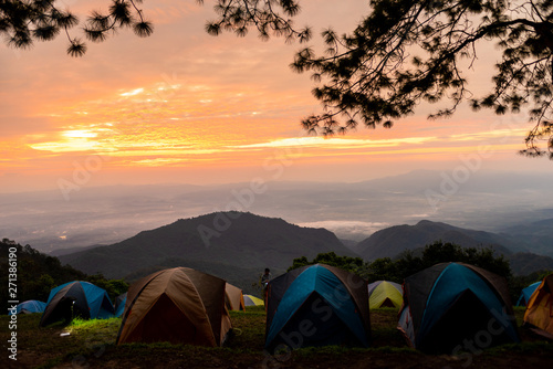 Fototapeta Naklejka Na Ścianę i Meble -  Adventures Camping tourism and tent ,view forest landscape , outdoor in morning and sunset sky at Mon Sone View point , Doi Pha Hom Pok National Park in Chiang Mai, Thailand. Concept Travel.