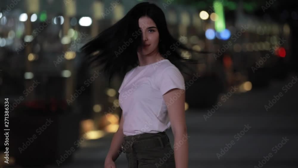 Cute woman enjoy a night walk in a city Cute woman enjoy a night walk in a city