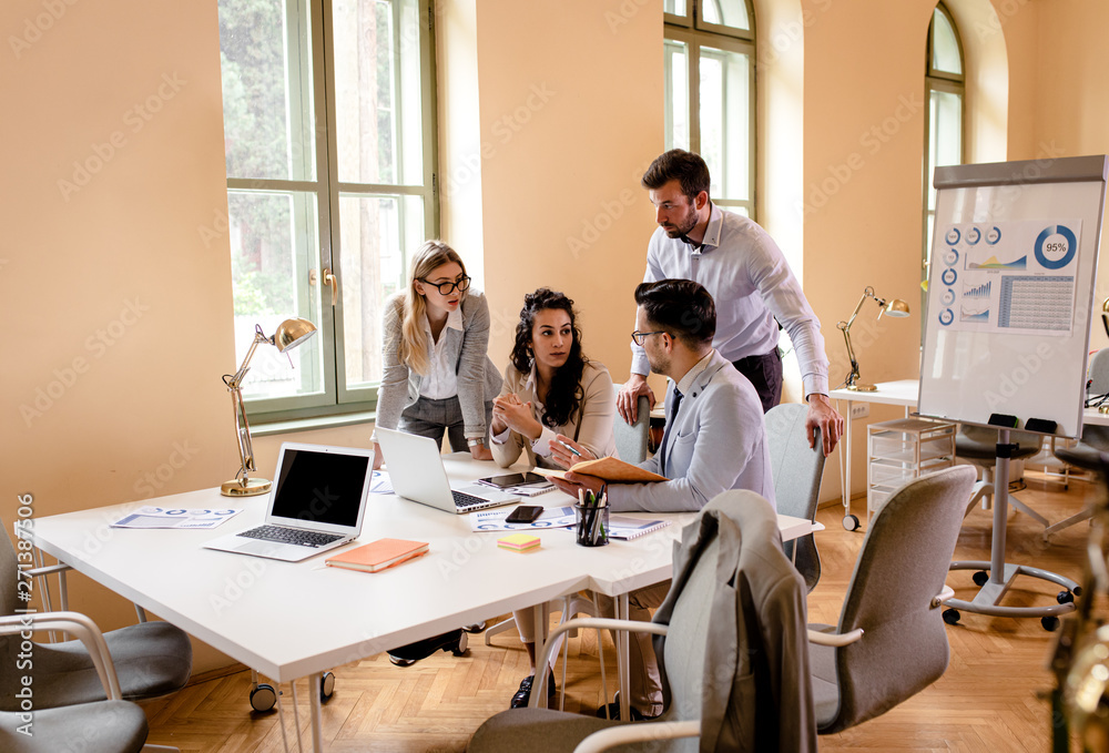 Group of young business people working together while sitting at the office desk. Group of young business people working together while sitting at the office desk.