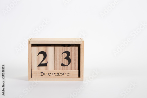 Wooden calendar December 23 on a white background