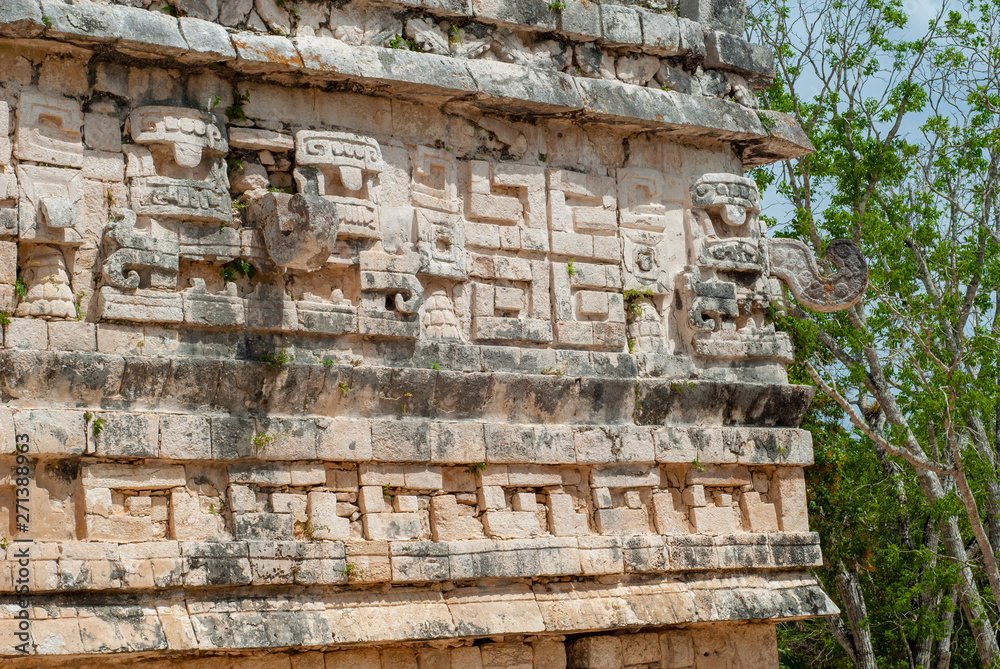 Decoration details engraved on the Mayan temple, in the archaeological area of Chichen Itza, on the Yucatan peninsula