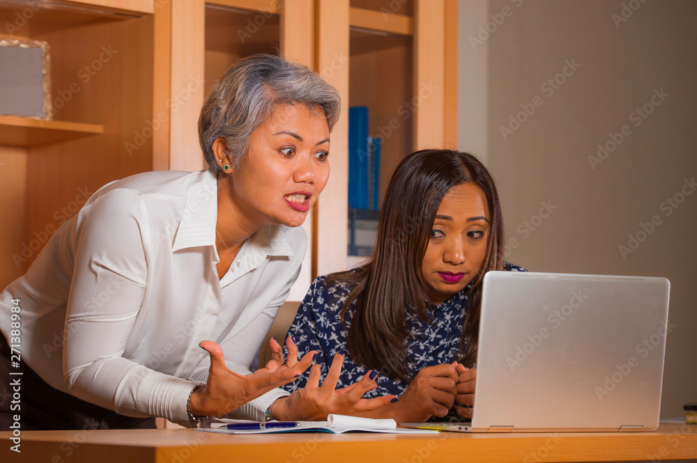 upset business woman nagging and scolding on employee girl angry for computer mistake in office boss or chief authority and assistant suffering reprimand upset business woman nagging and scolding on employee girl angry for computer mistake in office boss or chief authority and assistant suffering reprimand