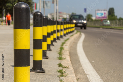 long line of yellow and black traffic signs to deter the cars around the road. © Valentina