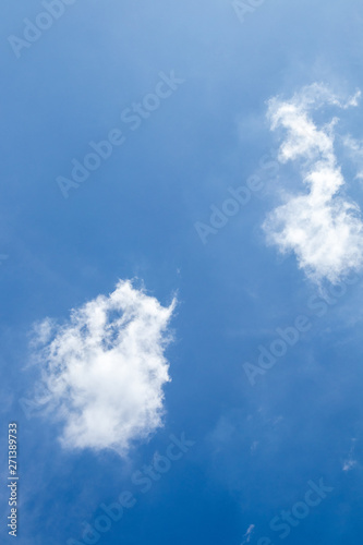 Blue sky background with white clouds.