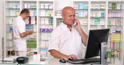 Pharmacist Activity in Drugstore Talk to Telephone and Introduce Data in Compute