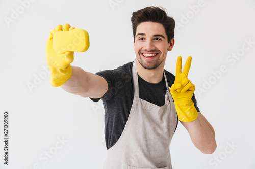 Handsome brunette houseman wearing apron photo