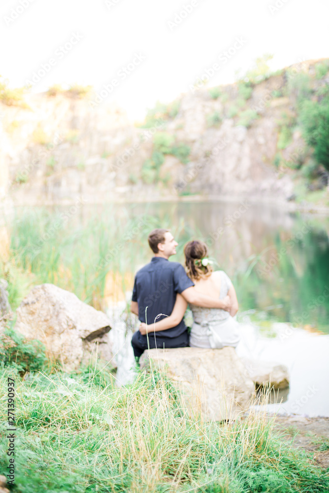 Elegant gentle stylish groom and bride near river or lake. Wedding couple in love Elegant gentle stylish groom and bride near river or lake. Wedding couple in love