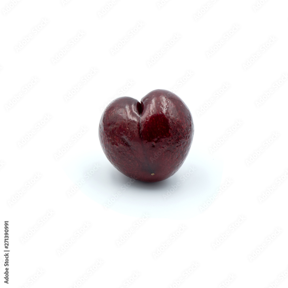 Reddish-purple cherries that are isolated on the white background