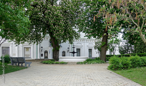 Vászonkép A courtyard with a fountain under blooming chestnuts in Kiev Pechersk Lavra