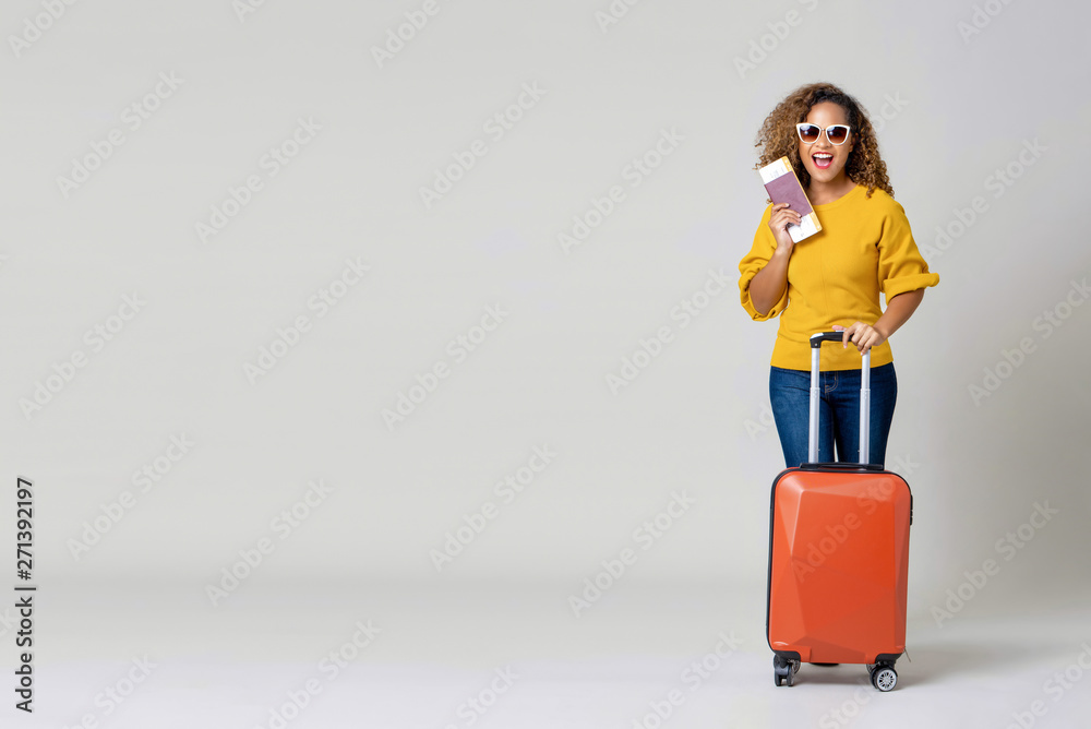 African American woman tourist with luggage holding passport and boarding pass African American woman tourist with luggage holding passport and boarding pass