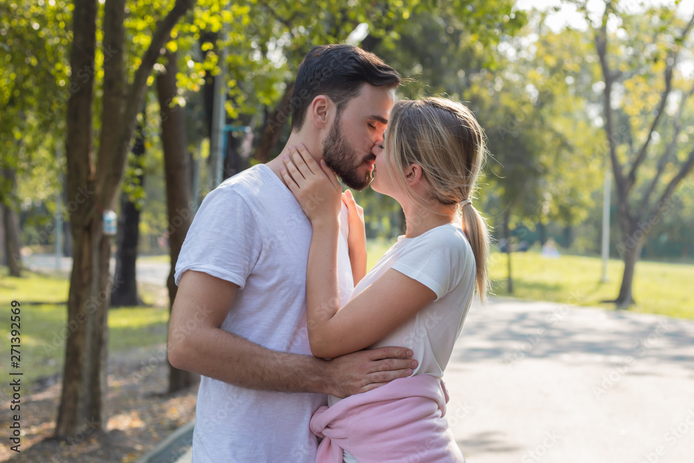 Fototapeta premium Couples standing kiss and hugging in the park.