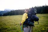 Adventure, travel, tourism, hike and people concept - man with beard and backpack hiking