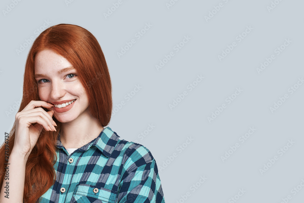 Sunny girl. Modern playful teenage girl touching lips and looking at the camera Sunny girl. Modern playful teenage girl touching lips and looking at the camera