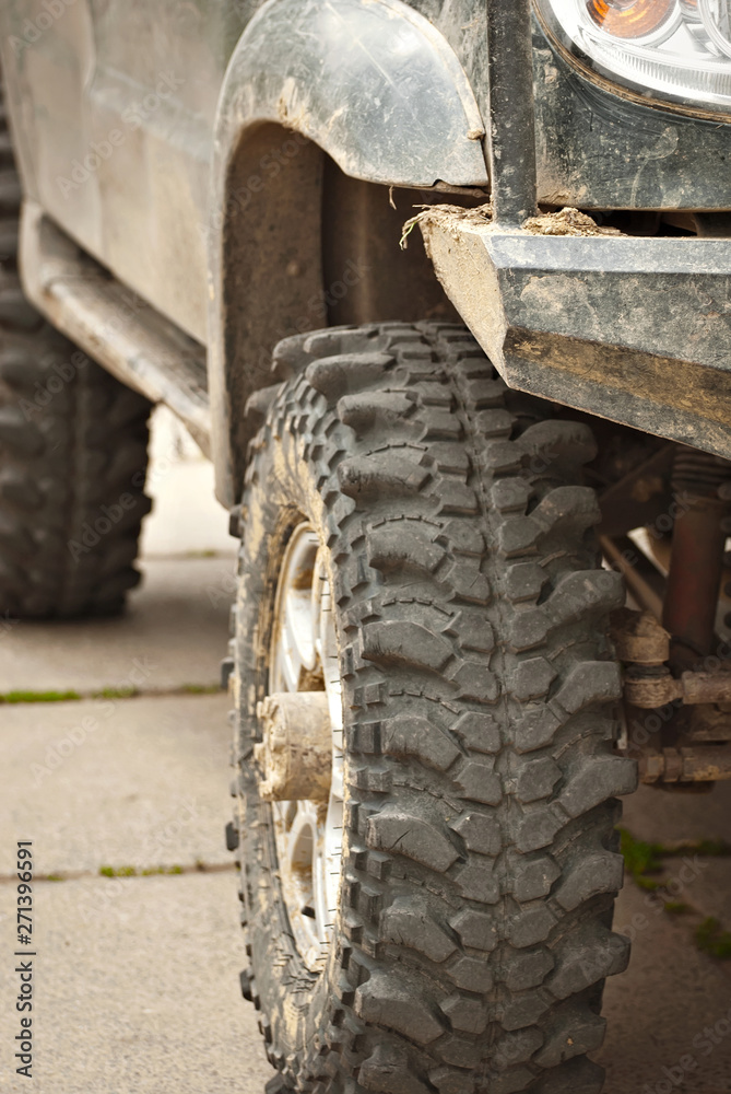 Wheels, lights and bumper are laced in a swamp. Dirty truck parts close up. Wheels, lights and bumper are laced in a swamp. Dirty truck parts close up.