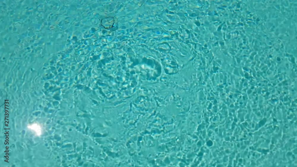 top static shot of Waving Clear Water In an empty Swimming Pool